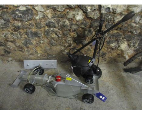 A searchlight electricity novelty light in the form of an F1 car, together with an anglepoise style lamp 