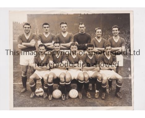 MANCHESTER UNITED     An 8" X 6" B/W Press team group from the 1957/8 season with stamps and legend on the back and date stam