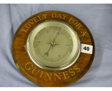 ANEROID BAROMETER IN A ROUNDEL INSCRIBED 'LOVELY DAY FOR A GUINESS' 21CM APPROX 