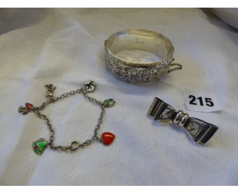 HM BIRMINGHAM SILVER ENGRAVED BANGLE WITH SAFETY CHAIN, CONTINENTAL .835 SILVER BOW BROOCH AND A SILVER AND ENAMEL CHARM BRAC