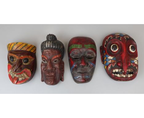 4 carved and polychrome tribal masks to include Japanese &amp; Indian Buddhist
