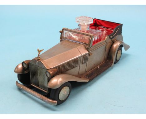 A novelty decanter, in the form of a veteran Rolls Royce tourer, clockwork musical mechanism, glass decanter and six tots, to