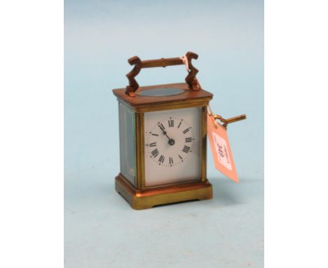 An early 20th century lacquered brass carriage clock, with enamelled dial and timepiece movement, with key, 5.5in.
