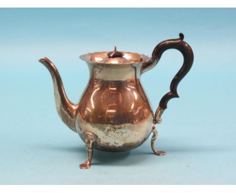 A silver teapot, bulbous-shape with black wood handle, scroll feet, Chester 1906, approx. 20oz. gross