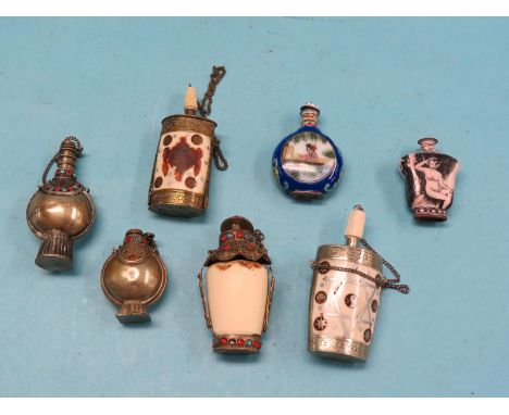 Six Eastern scent bottles, bone, metal and porcelain, tallest 3.25in., and a European enamel scent bottle painted with a nude