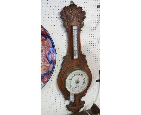 A carved oak wheel barometer, with thermometer dial, 36in. 