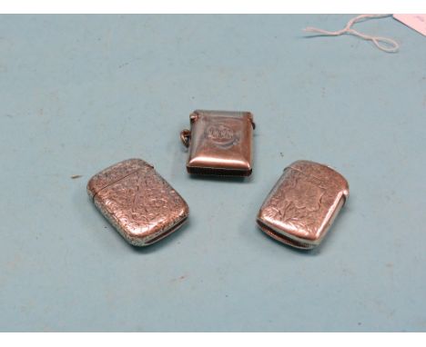 Two late Victorian engraved silver vesta cases, and an engine-turned silver vesta case 