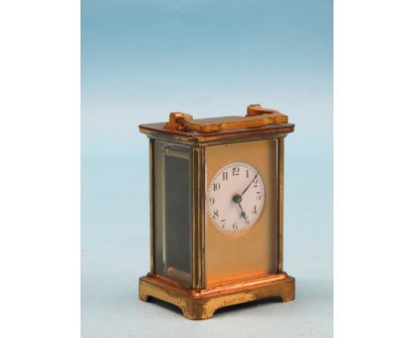 A French brass carriage clock, circular enamelled dial and timepiece movement, in brass case, 5.75in.