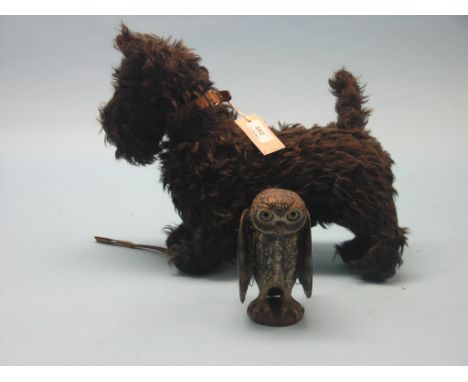 A Chiltern Toys Scottie Dog, 14in. and a French painted and cast aluminium toy owl with mechanical wings, 6in.