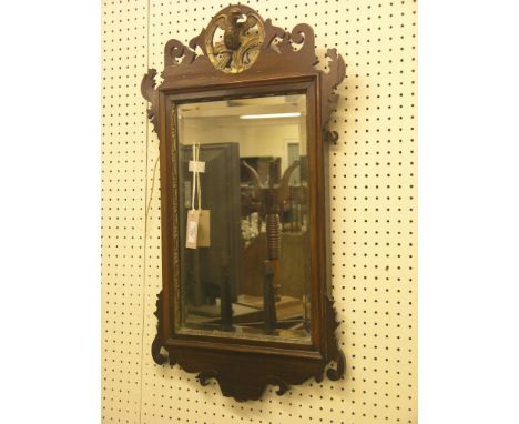 A Victorian Chippendale mahogany wall mirror, with carved and parcel-gilt eagle cresting, bevelled plate, 2ft. 4in. high 