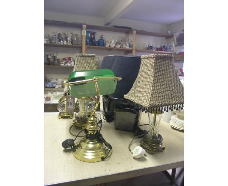 A brass desk lamp, with green glass shade, two pairs of brass table lamps, with cut glass stems and a pair of ceramic table l