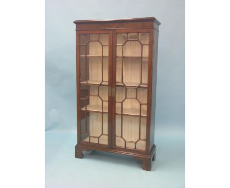 A 19th century mahogany bookcase, (modified) pair of full-length astragal-glazed doors enclosing lined interior with three ad