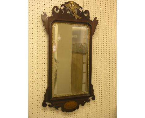 A Chippendale-style mahogany wall mirror, pierced cresting carved with gilded bird, inlaid shell to apron, frame 3ft. x 1ft. 