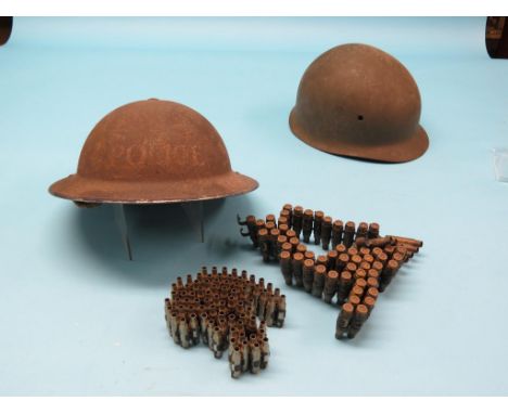 Two WWII metal helmets, German and Police, various rounds of amunition, replica rifle and pistol, military bugle, etc. 