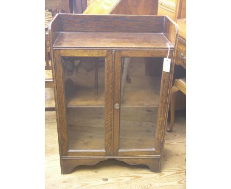 A solid, dark oak dwarf bookcase, single shelf enclosed by a pair of glazed doors, 2ft. 