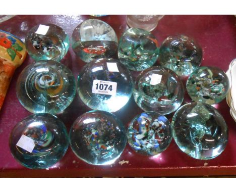 Twelve old bottle glass paperweights with internal enamel decoration of various size and form - various condition