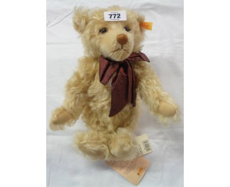 A Steiff Millennium Classic Teddy bear with brown bow, button to ear and tags