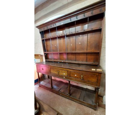 A 1.82m 18th Century oak two part potboard dresser with original forged iron hooks to the three shelf open plate rack, over a