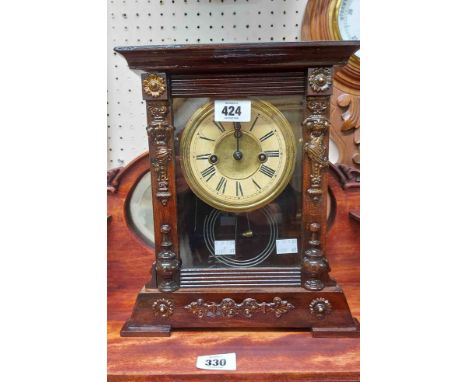 An old American shelf clock with visible mercury effect pendulum and gong striking movement