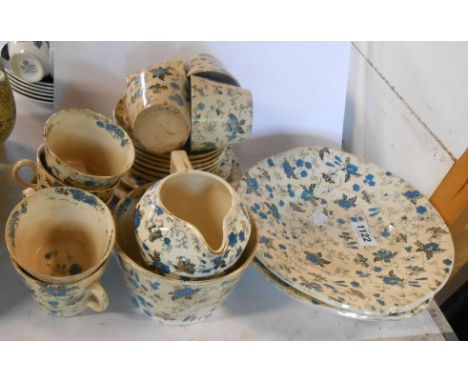 A quantity of 19th Century Bovey Tracey Pottery Company teaware decorated in the Pompador pattern including cups and saucers,
