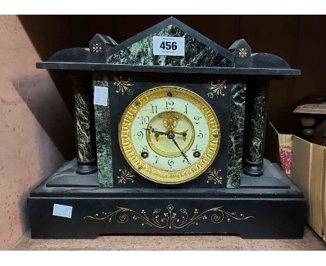 A late Victorian black slate and marble cased mantel clock with visible escapement and Ansonia gong striking movement