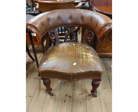 A 19th Century mahogany framed bow elbow chair with worn button back rexine upholstery and pierced acanthus scrolls, set on s