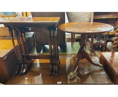 A nest of three reproduction mahogany and cross banded tea tables - sold with a similar 53cm diameter pedestal table, set on 