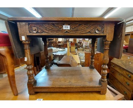 A 62cm vintage polished drop-leaf coffee table with antique style carved decoration and undertier, set on turned supports