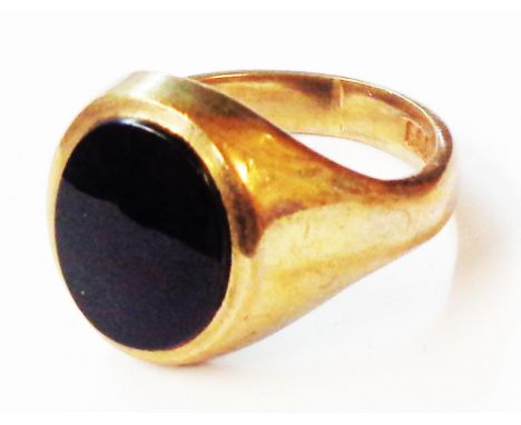 A 9ct. gold black onyx oval panel signet ring - size M