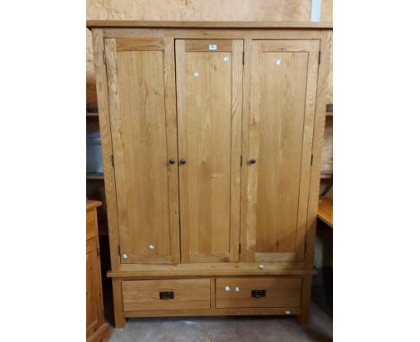 A 1.35m modern light oak triple wardrobe with hanging space and two drawers under