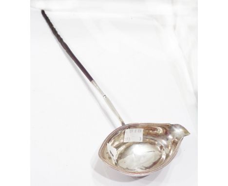 A London silver toddy ladle with long twisted whale bone handle - small dent to bowl