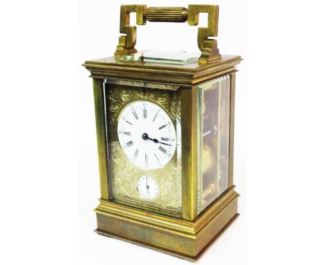 A brass and bevelled glass cased Aiguilles carriage clock with decorative engraved front and circular dials, with eight day s
