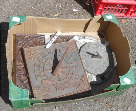 A box containing five sundial tops