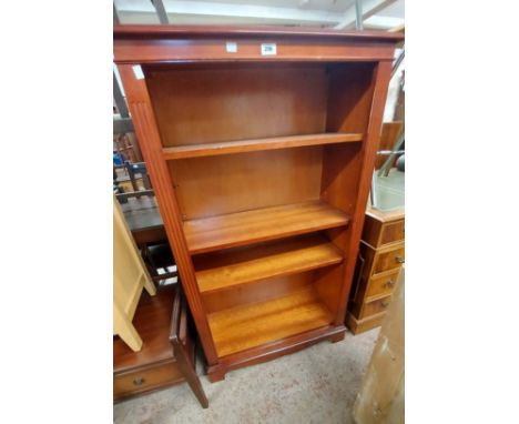 A 78cm reproduction mahogany four shelf open bookcase, set on bracket base