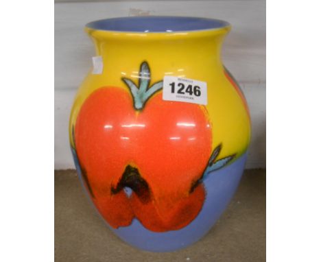 A Poole Pottery vase with stylised painted flowerheads in a bold colour palette