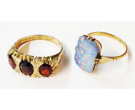 A marked 10k doublet opal panel ring - sold with a silver gilt three stone garnet ring - sizes O and R respectively