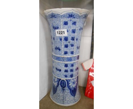 An antique Chinese porcelain vase of waisted cylindrical form with all-over hand painted blue decoration depicting flowers an