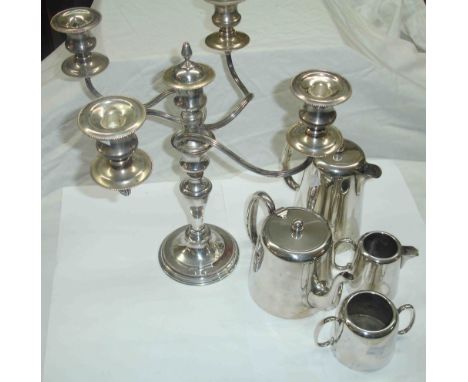 A silver plated four piece tea set - sold with a plated four branch five light candelabrum