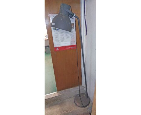 A vintage grey painted metal industrial style standard lamp
