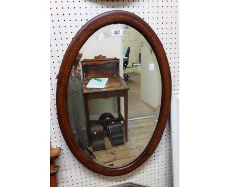 Three assorted wall mirrors comprising an Edwardian inlaid framed bevelled oval, a vintage frameless and a satin walnut frame