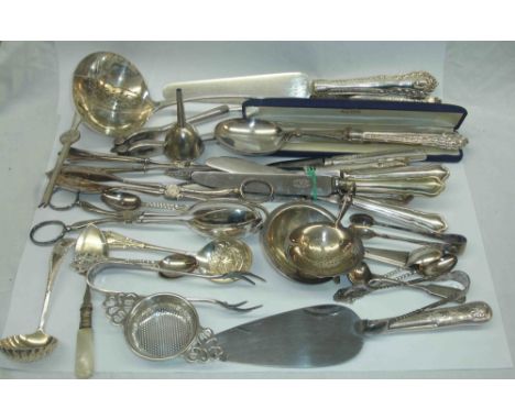 A crate containing a quantity of silver plated serving and other cutlery including a large partitioned ladle and meat skewer,