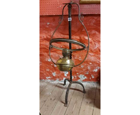 An old brass hanging oil lamp - sold with a wrought iron stand