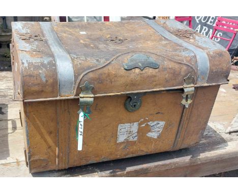 A vintage metal travelling trunk containing a selection of items including decorative metal box, bird feeder, etc.