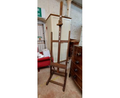 A vintage stained beech and oak artist's studio easel