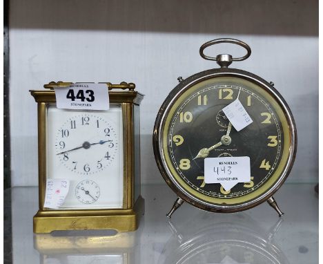 An old brass and bevelled glass cased carriage alarm clock with eight day bell striking movement - dial cracked - sold with a