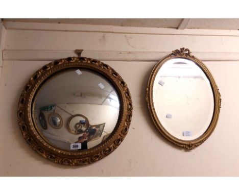 A vintage gilt plaster framed convex wall mirror with decorative pierced border - sold with another small gilt framed wall mi