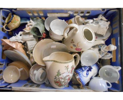 A crate containing a quantity of assorted ceramic and other items including figurines, jugs, cups and saucers, etc. - sold wi