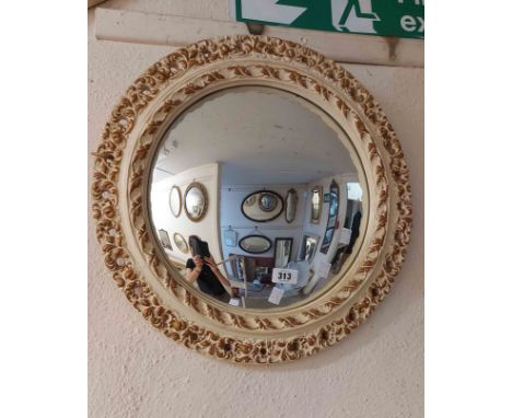 A vintage cream and parcel gilt painted plater framed convex wall mirror with decorative pierced border
