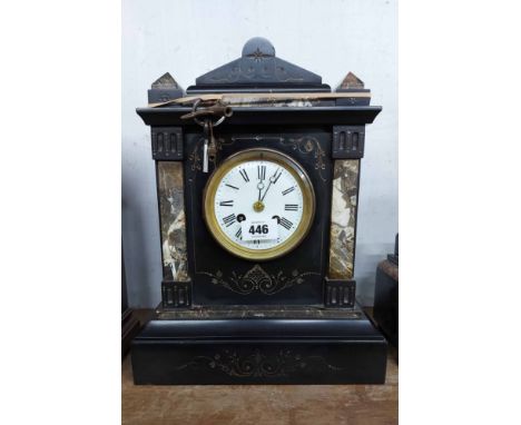 A late Victorian black slate and marble cased mantel clock with incised gilded decoration and eight day gong striking movemen