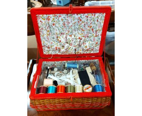 A vintage lift-top wicker sewing box and contents